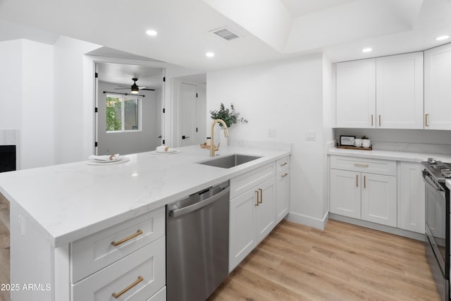2935 N 68th St Unit 205, Scottsdale, AZ 85251 - kitchen with dishwasher, a peninsula, ceiling fan, black range, and white cabinetry