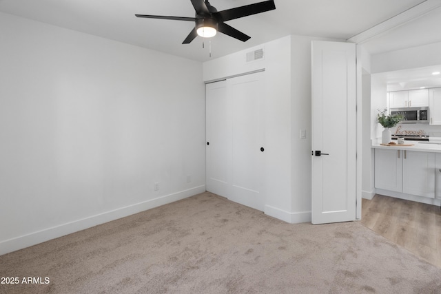 2935 N 68th St Unit 205, Scottsdale, AZ 85251 - unfurnished bedroom with light carpet, a closet, and ceiling fan