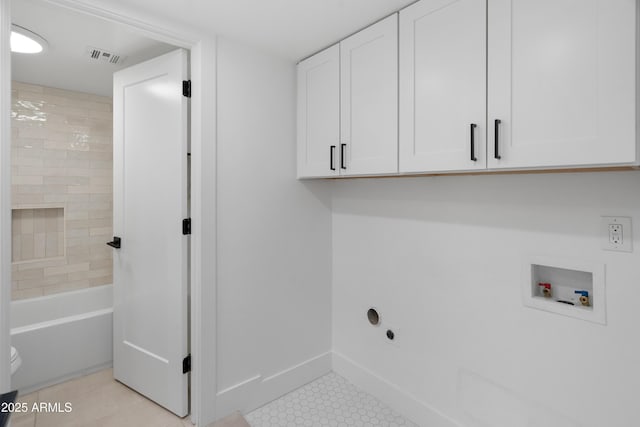 2935 N 68th St Unit 205, Scottsdale, AZ 85251 - laundry area with cabinet space, hookup for a washing machine, light tile patterned floors, and electric dryer hookup