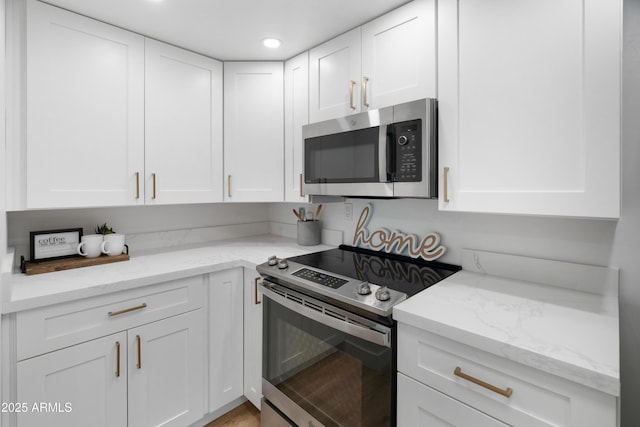 2935 N 68th St Unit 205, Scottsdale, AZ 85251 - kitchen featuring stainless steel appliances, white cabinets, light stone counters, and recessed lighting