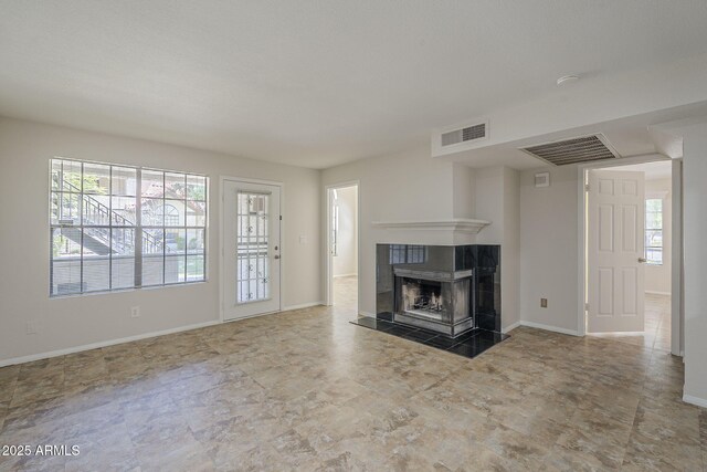 2333 E Southern Ave Unit 1023, Tempe, AZ 85282 - unfurnished living room featuring a tiled fireplace and baseboards