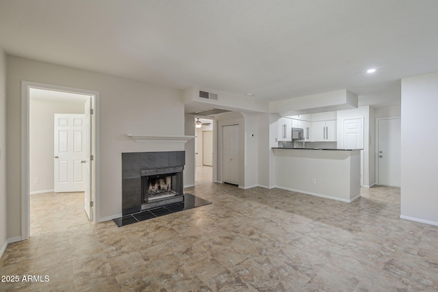 2333 E Southern Ave Unit 1023, Tempe, AZ 85282 - unfurnished living room featuring a fireplace, ceiling fan, and recessed lighting