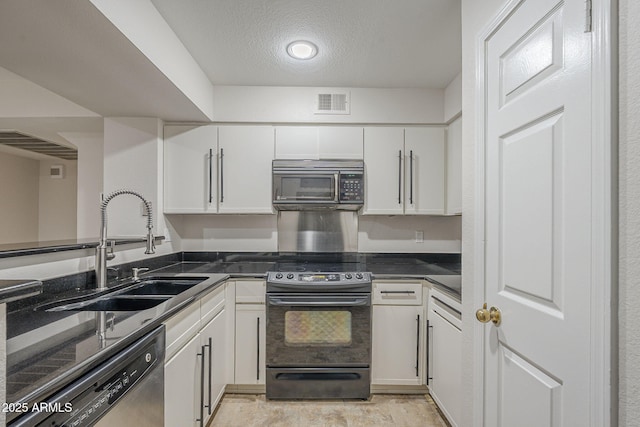 2333 E Southern Ave Unit 1023, Tempe, AZ 85282 - kitchen featuring appliances with stainless steel finishes, white cabinets, and a textured ceiling