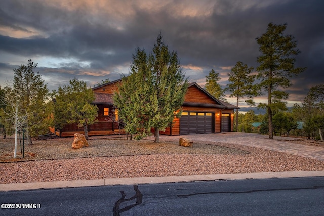 view of front of house with an attached garage and decorative driveway