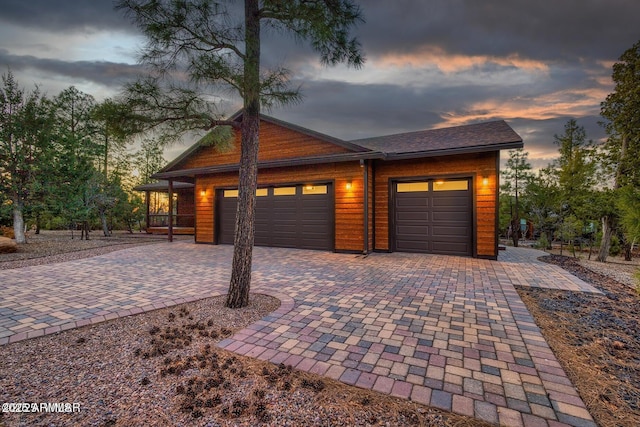 garage with decorative driveway