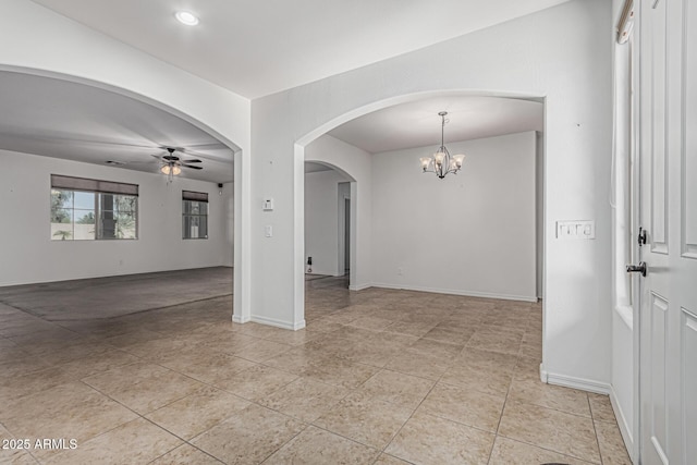 unfurnished room with ceiling fan with notable chandelier, light tile patterned floors, arched walkways, baseboards, and recessed lighting