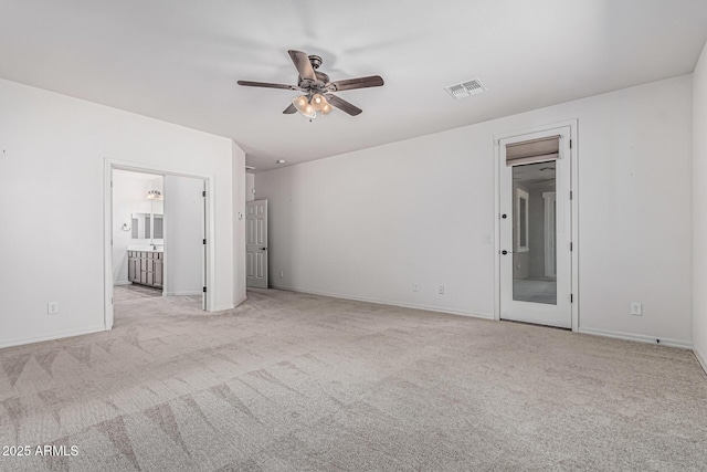 unfurnished bedroom featuring connected bathroom, baseboards, visible vents, and carpet