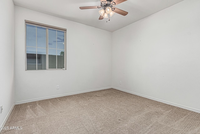 unfurnished room featuring carpet floors, a ceiling fan, and baseboards