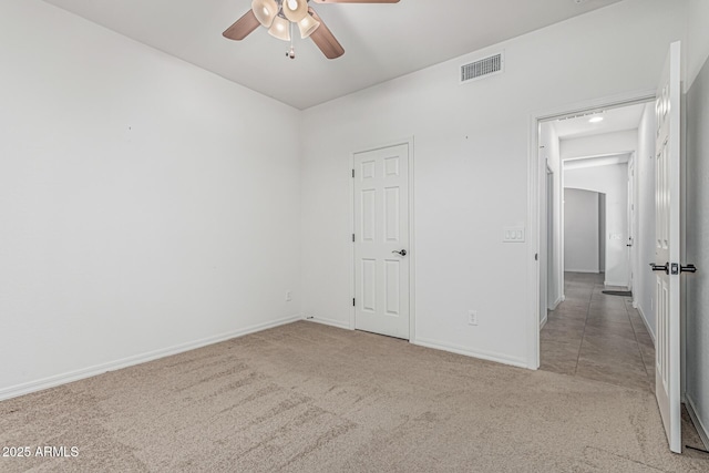 unfurnished bedroom with baseboards, visible vents, carpet, and ceiling fan