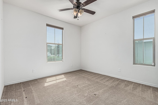 unfurnished room featuring baseboards, carpet flooring, and ceiling fan