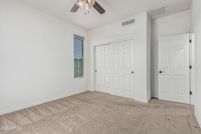 unfurnished bedroom featuring carpet floors, visible vents, and baseboards