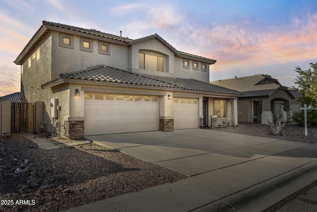 mediterranean / spanish-style home featuring a garage