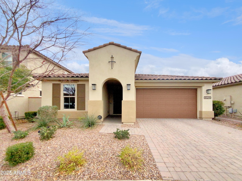 mediterranean / spanish house featuring a garage