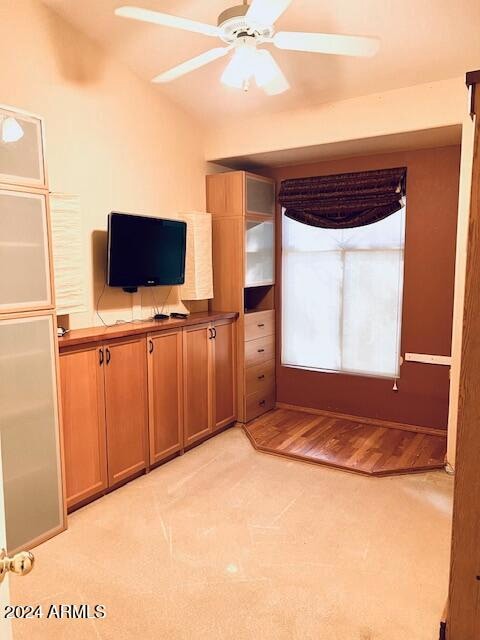 unfurnished living room with light wood-type flooring and ceiling fan