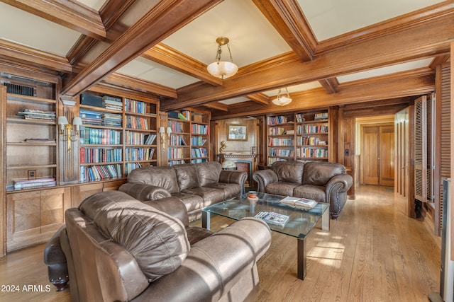 living area featuring wood-type flooring, bookshelves, wood walls, coffered ceiling, and beamed ceiling