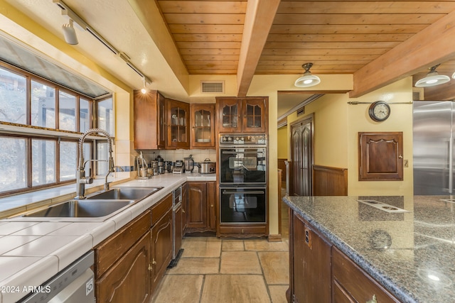 kitchen featuring visible vents, wood ceiling, appliances with stainless steel finishes, beamed ceiling, and a sink