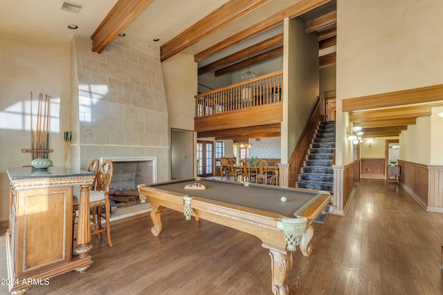 playroom with a wainscoted wall, visible vents, beam ceiling, and wood finished floors