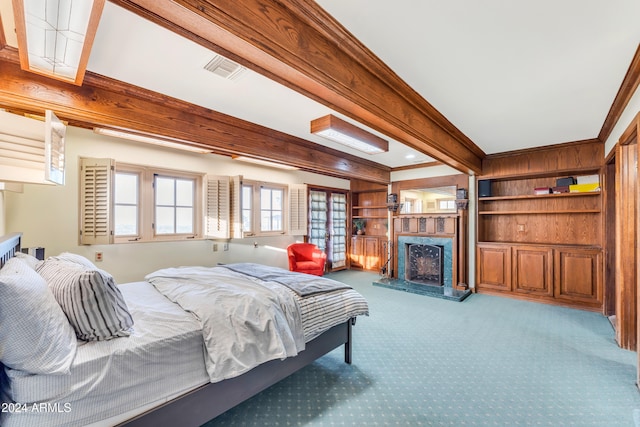 bedroom featuring a high end fireplace, carpet flooring, beamed ceiling, and visible vents