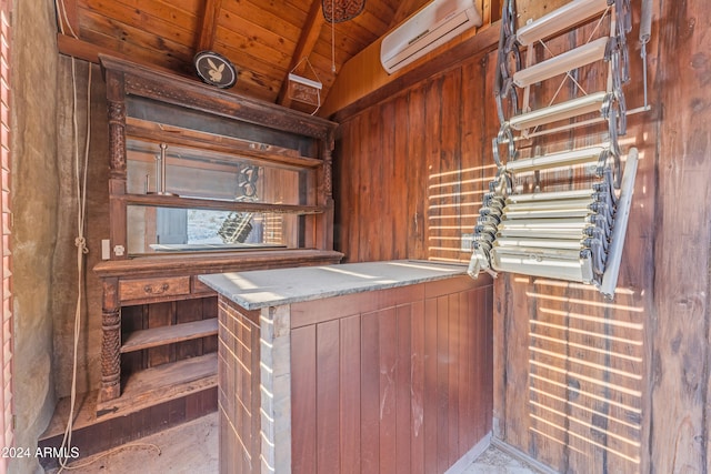 bar with lofted ceiling, wooden ceiling, a wall mounted air conditioner, and wooden walls