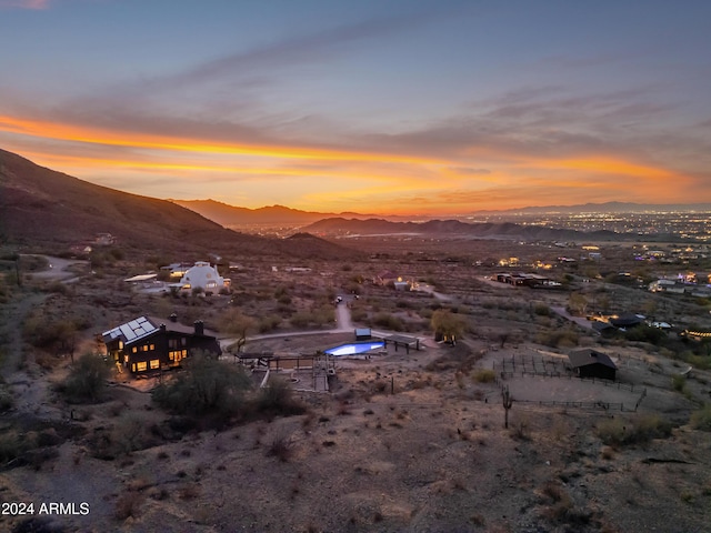 aerial view at dusk featuring a mountain view