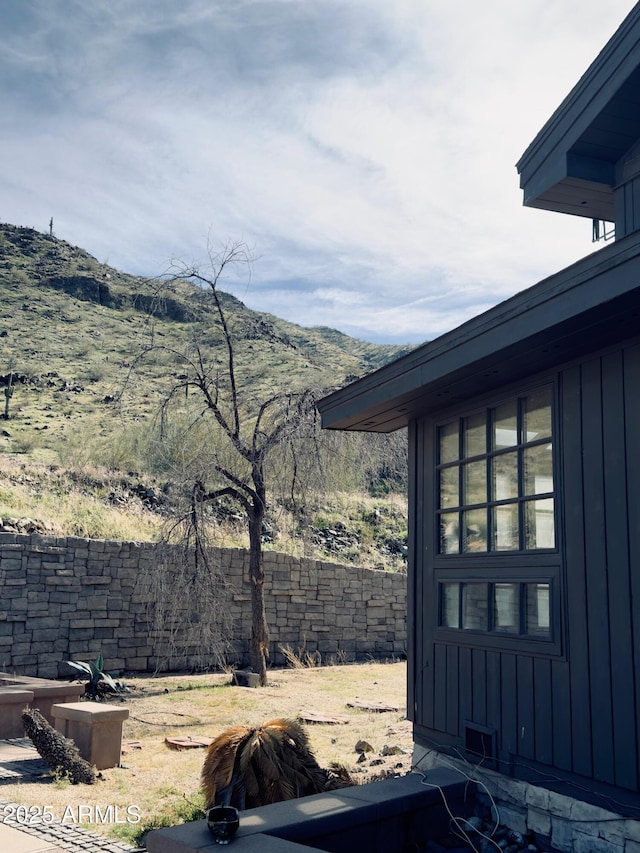 view of yard featuring fence and a mountain view