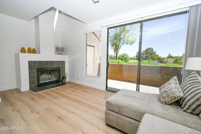 5122 E Shea Blvd Unit 1043, Scottsdale, AZ 85254 - living area featuring wood finished floors, baseboards, and a tile fireplace