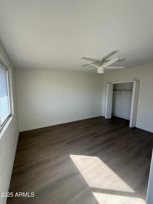 unfurnished bedroom featuring a closet, dark hardwood / wood-style floors, and ceiling fan