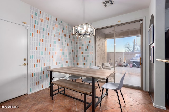 tiled dining space featuring visible vents and a chandelier