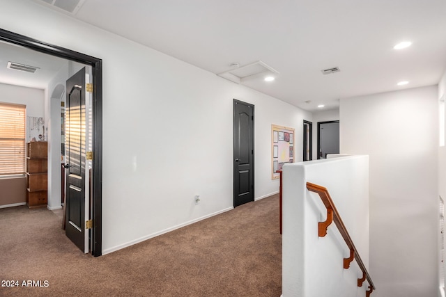 corridor featuring recessed lighting, visible vents, baseboards, an upstairs landing, and carpet