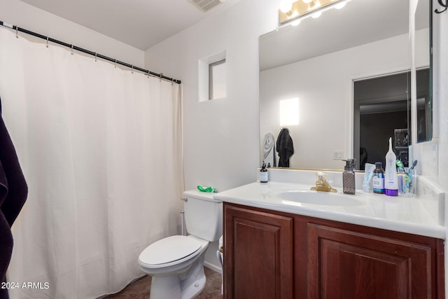 bathroom featuring toilet, a shower with curtain, visible vents, and vanity