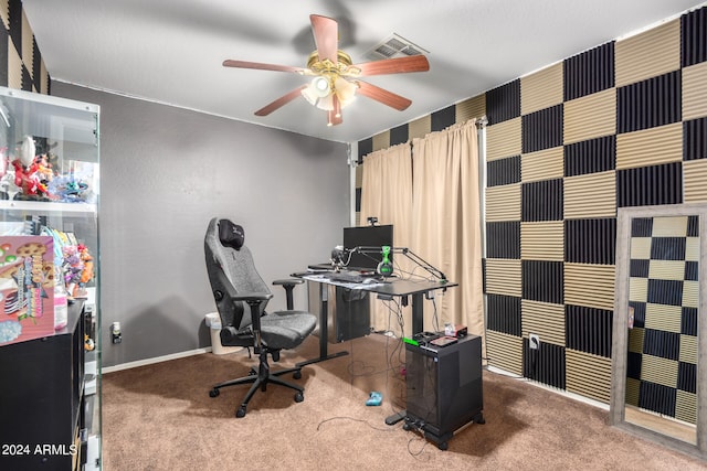 home office with a ceiling fan, carpet flooring, visible vents, and baseboards