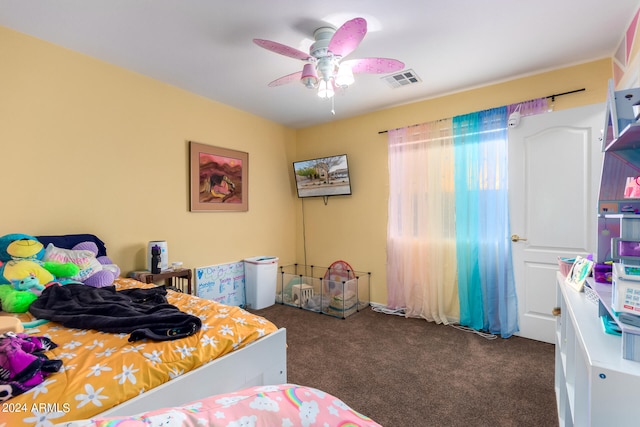 bedroom with carpet floors, visible vents, and a ceiling fan