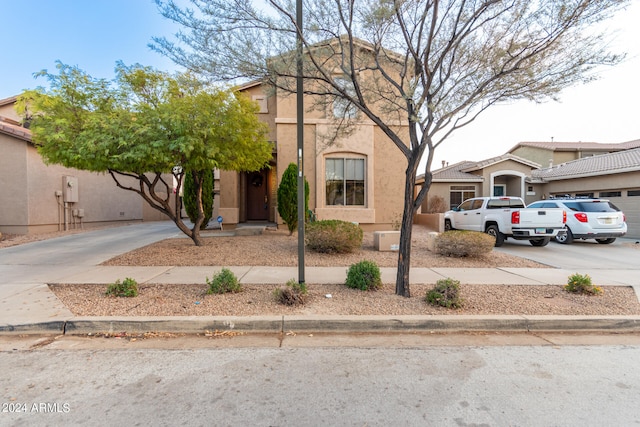 view of front of house with driveway and stucco siding