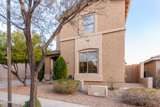 view of front of house with a tiled roof and stucco siding