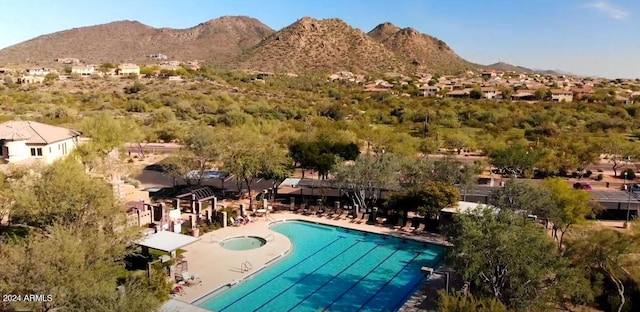 view of swimming pool with a mountain view