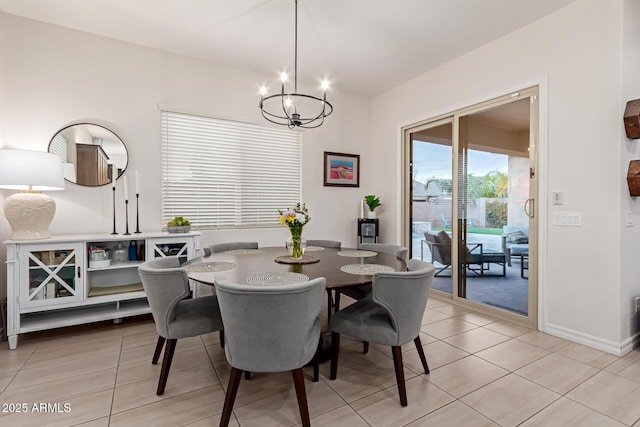 dining space featuring light tile patterned floors and a chandelier