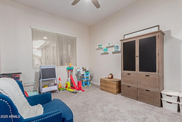 recreation room with ceiling fan and carpet