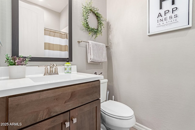 bathroom featuring vanity and toilet