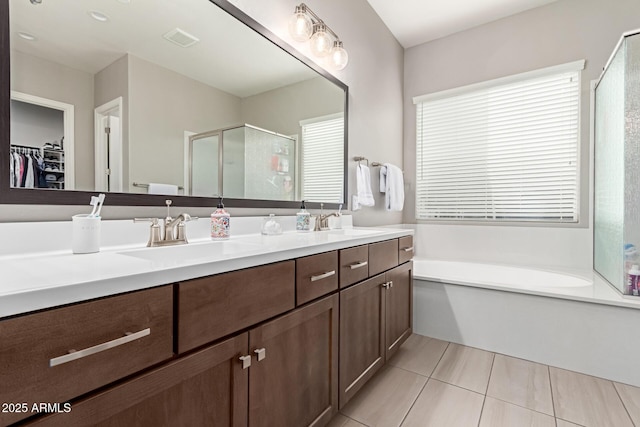 bathroom featuring vanity, tile patterned floors, and shower with separate bathtub