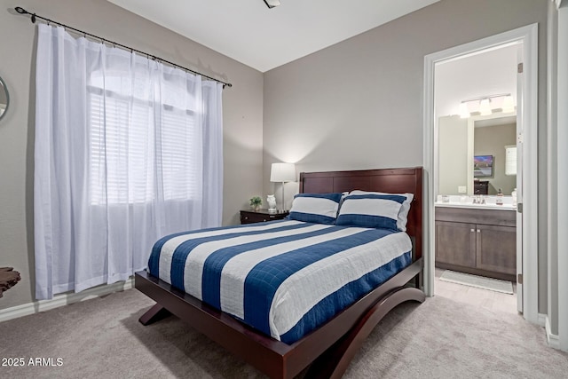 carpeted bedroom with ensuite bath