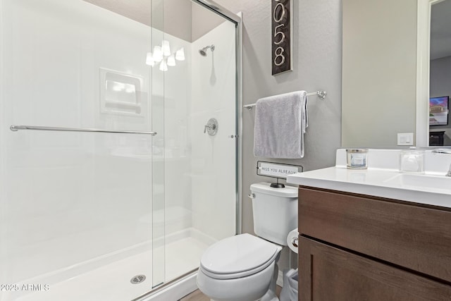 bathroom with vanity, an enclosed shower, a textured ceiling, and toilet