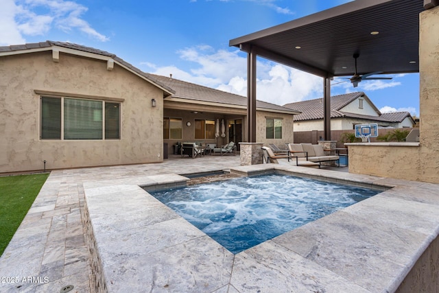 view of swimming pool with an outdoor living space, ceiling fan, and a patio area