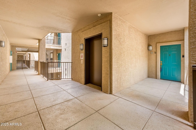 14950 W Mountain View Blvd Unit 7209, Surprise, AZ 85374 - property entrance featuring stucco siding, elevator, and a balcony