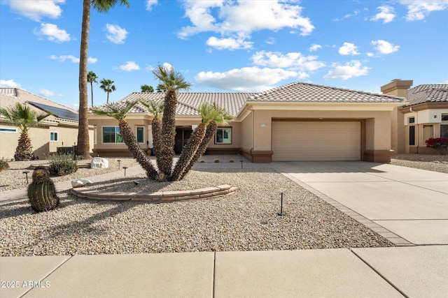 view of front of home with an attached garage, stucco siding, driveway, and a tiled roof