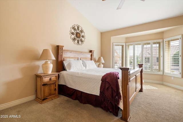 bedroom featuring light carpet, ceiling fan, baseboards, and lofted ceiling