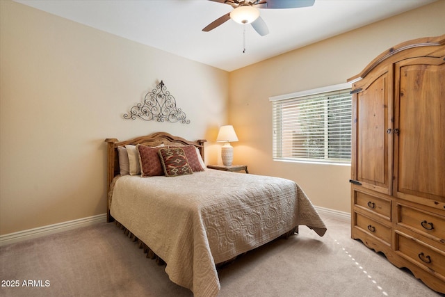 bedroom with light carpet, ceiling fan, and baseboards