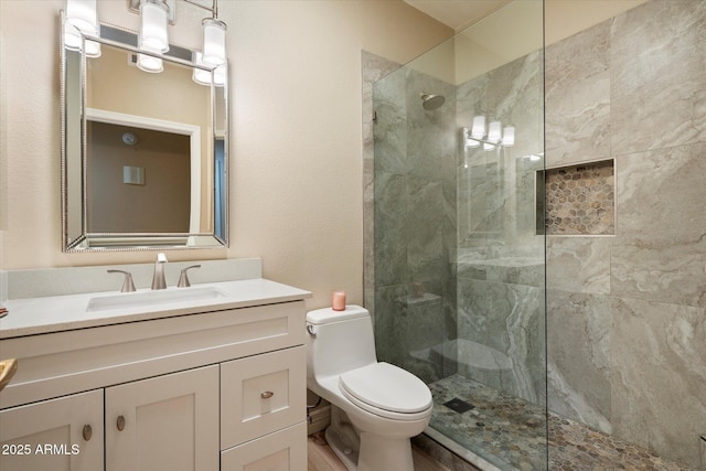 bathroom featuring a walk in shower, vanity, and toilet