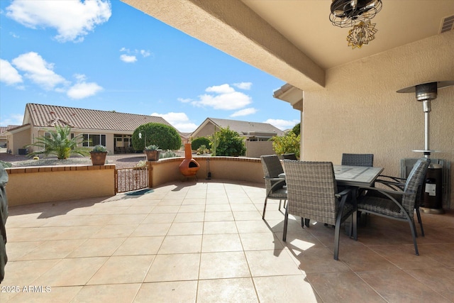 view of patio featuring outdoor dining area, fence, and visible vents