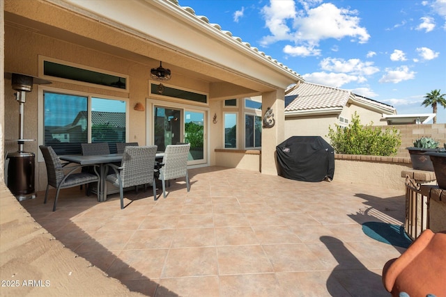 view of patio with outdoor dining area and a grill