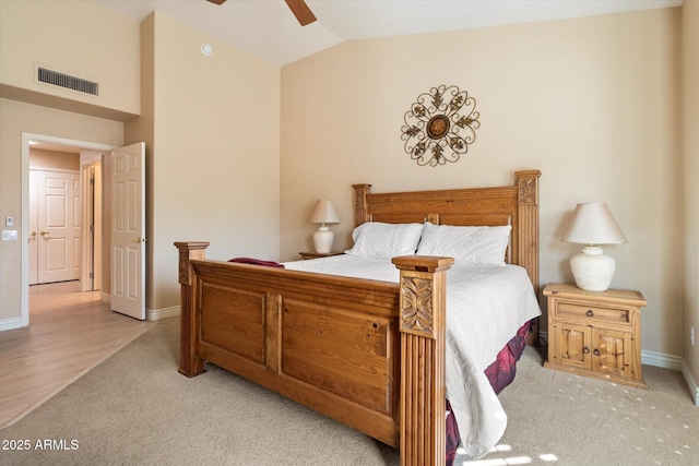 bedroom with light colored carpet, visible vents, a ceiling fan, vaulted ceiling, and baseboards